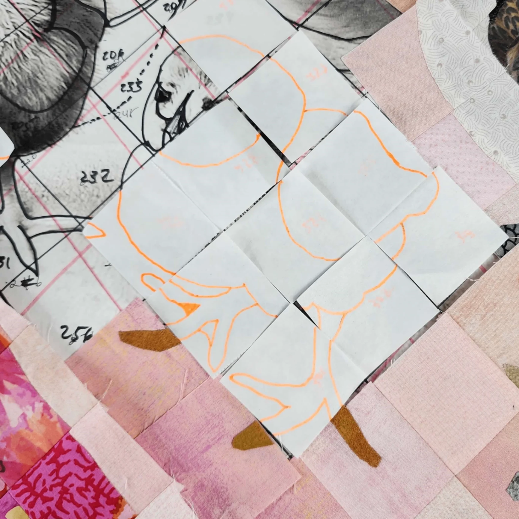 Fabric pieces arranged on a cutting mat
