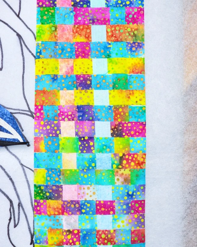 Batik fabric cut into quarter-inch strips and woven into Spyger's collar
